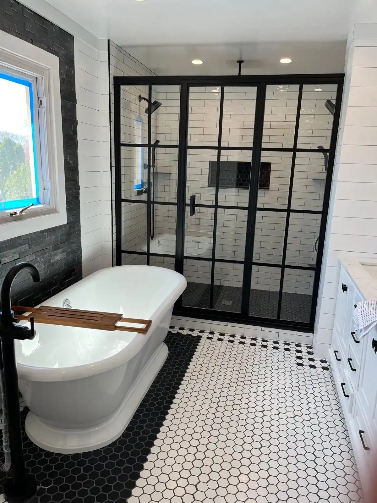 Large frameless wall-to-wall vanity mirror above a double sink